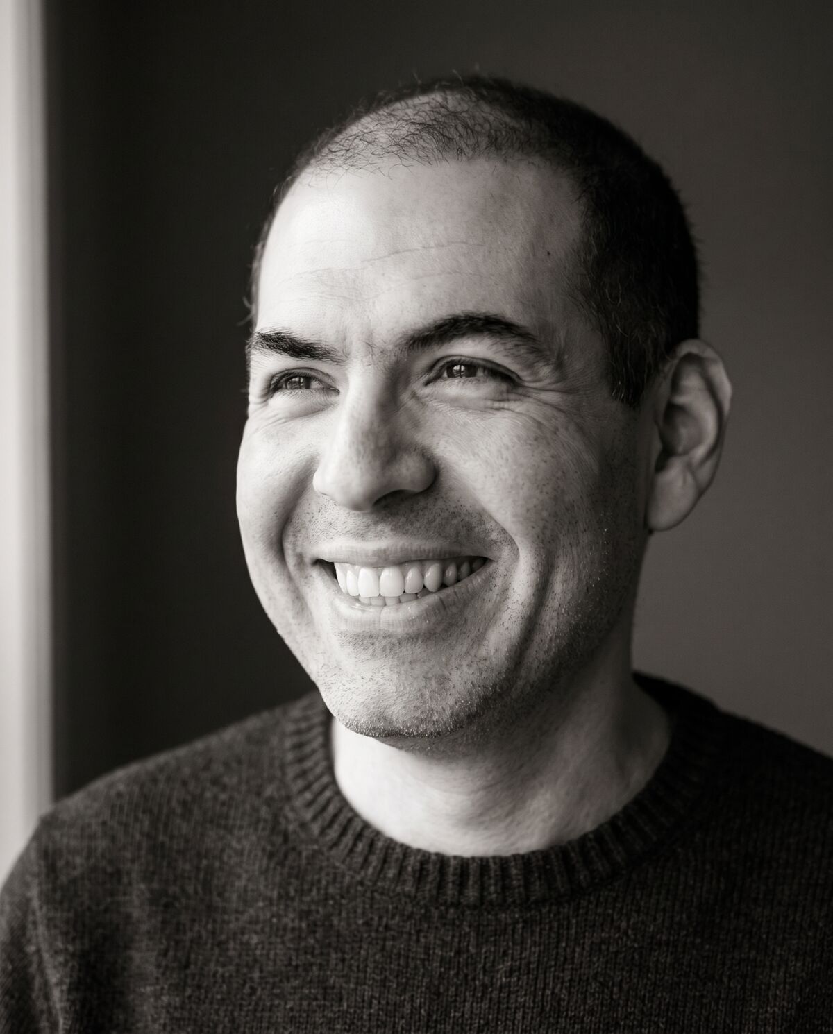 Thiago Lourenço Martins smiling, black and white portrait